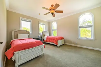 a bedroom with two beds and a ceiling fan at Luxe Wine Country Estate with Orchard-Facing Balcony in Temecula
