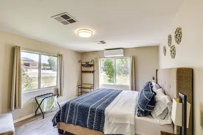a bedroom with a bed and two windows at Escondido Vineyard Estate Walk to Wineries! in Escondido