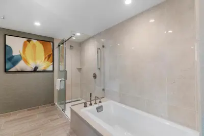 a bathroom with a tub and a painting on the wall at Pala Mesa Resort in Fallbrook