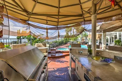 an outdoor kitchen with a view of a pool at Luxe San Diego Getaway with Pool and Ocean Views in San Diego