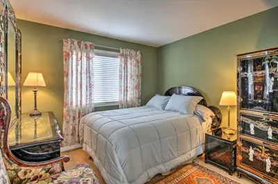 a bedroom with a bed and a chair and a window at Luxe San Diego Getaway with Pool and Ocean Views in San Diego