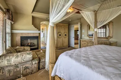 a bedroom with a bed and a fireplace at Luxe San Diego Getaway with Pool and Ocean Views in San Diego