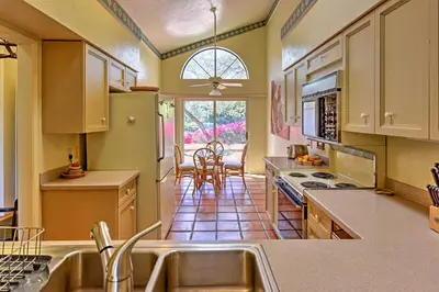 a kitchen with a sink and a table with chairs at Borrego Springs Condo with Private Patio and Views! in Borrego Springs