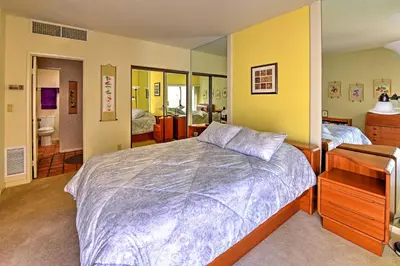 a bedroom with a large bed and yellow walls at Borrego Springs Condo with Private Patio and Views! in Borrego Springs