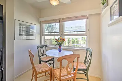 a dining room with a table and chairs and a window at Oceanside Home with Yard - Walk to Beach and Pier in Oceanside