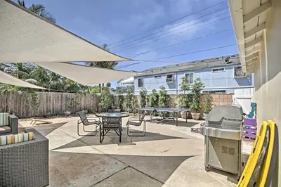 a patio with a table and chairs and a grill at Oceanside Home with Yard - Walk to Beach and Pier in Oceanside