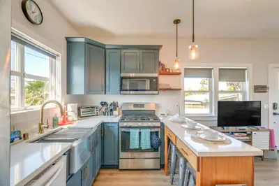 a kitchen with blue cabinets and a stove top oven at San Diego Guest House Apartment with Patio and Hot Tub in San Diego