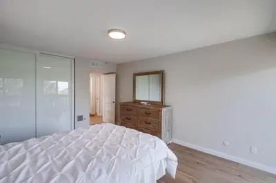 a bedroom with a bed with a mirror and a dresser at Beach Access Oceanview SBTC331 Condo in Solana Beach