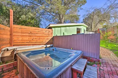 a hot tub in a backyard with a fence at La Jolla Home and Detached Suite Hot Tub and Backyard in San Diego