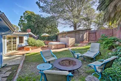 a backyard with a table and chairs and a grill at La Jolla Home and Detached Suite Hot Tub and Backyard in San Diego