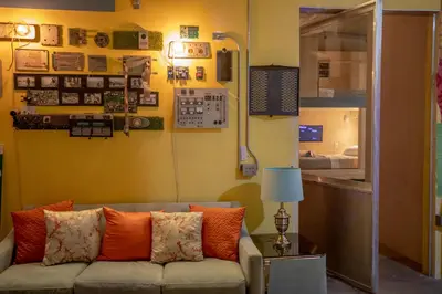 a living room with a couch with orange pillows at PodShare San Diego in San Diego