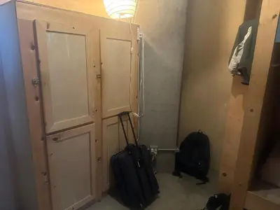 a room with a cabinet and a backpack and a suitcase at PodShare San Diego in San Diego