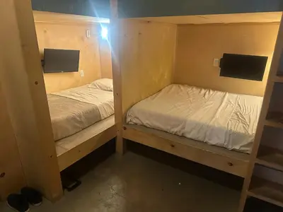 two bunk beds in a small room at PodShare San Diego in San Diego