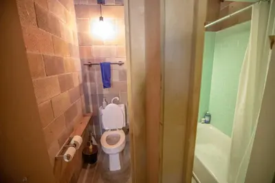 a small bathroom with a toilet and a shower at PodShare San Diego in San Diego