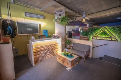 a living room with a couch and a chair and a tv at PodShare San Diego in San Diego