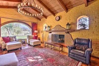 a living room filled with furniture and a fireplace at Equestrian Estate with Horse Stables and Pool! in Valley Center