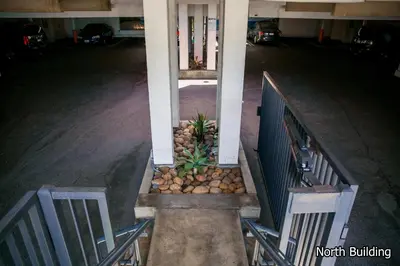 an empty parking lot with two chairs and a column at 14 West Laguna Beach in Laguna Beach