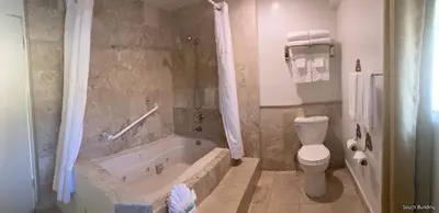 a bathroom with a tub and a toilet and a sink at 14 West Laguna Beach in Laguna Beach