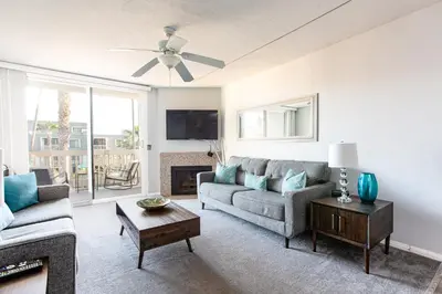 a living room with a couch and a table at 3 Bedroom! - Complex is on the beach with huge pool in Oceanside