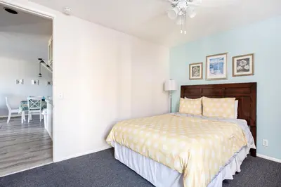 a bedroom with a bed and a dining room at 3 Bedroom! - Complex is on the beach with huge pool in Oceanside