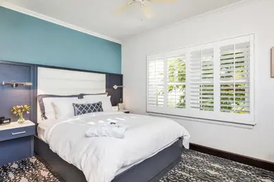 a bedroom with a large bed and a window at Hotel Marisol Coronado in San Diego