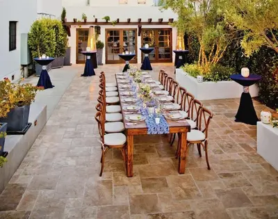 a long table with chairs and plates on it at Hotel Marisol Coronado in San Diego