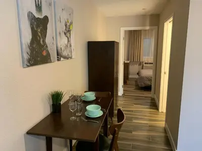 a dining room with a table and a room with a bedroom at Solis Place in Old Town in San Diego