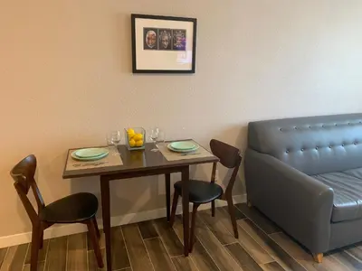 a dinning room with a table and a couch at Solis Place in Old Town in San Diego