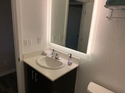 a bathroom with a sink and a mirror at Solis Place in Old Town in San Diego