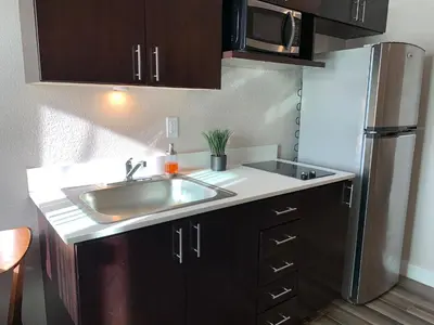 a kitchen with a sink and a refrigerator at Solis Place in Old Town in San Diego