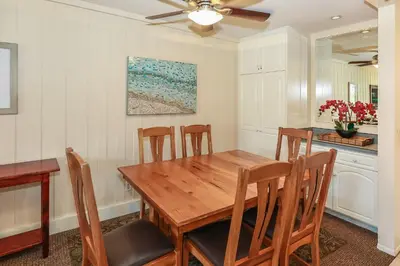 a dining room with a wooden table and chairs at G218 - Palms Away in Oceanside