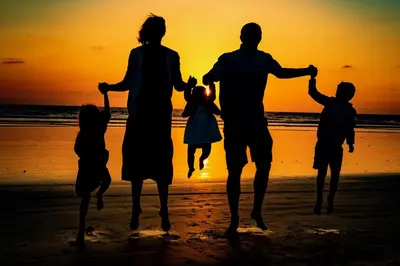 a family walking on the beach at sunset at G313 - Panoramic Perfection in Oceanside