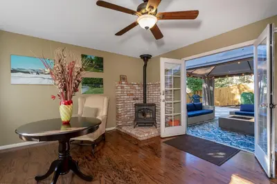a living room with a ceiling fan and a fireplace at The Heart of Julian in Julian
