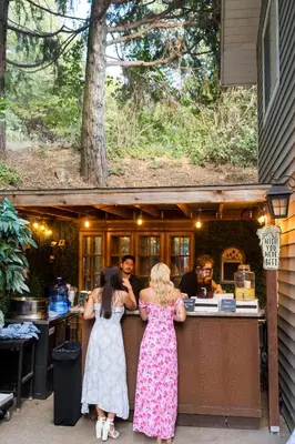 a group of people standing at a bar at The Heart of Julian in Julian