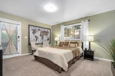 a bedroom with a bed and a window and a chair at The Heart of Julian in Julian