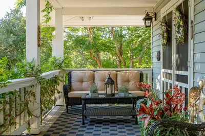 a screened porch with a couch and a table at The Heart of Julian in Julian