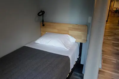 a bedroom with a bed with a wooden headboard at Stay Classy in San Diego