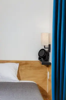a bedroom with a bed and a lamp and a phone at Stay Classy in San Diego