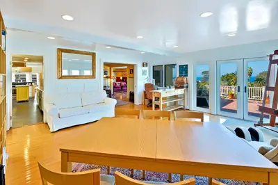 a dining room and living room with a table and chairs at Casa Dolce in San Diego