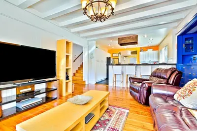 a living room with a couch and a tv at Casa Dolce in San Diego