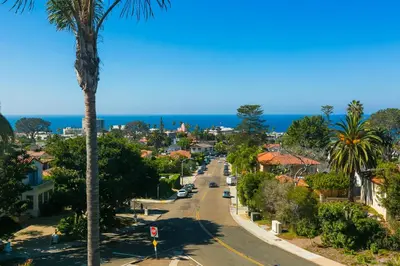 a street in a town with a palm tree at Casa Dolce in San Diego