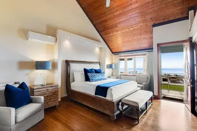 a bedroom with a bed and a chair and a window at ENC-183 - SeaBluffe Escape in Encinitas