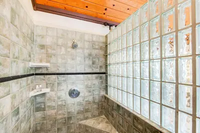 a bathroom with a shower with tiled walls at ENC-183 - SeaBluffe Escape in Encinitas