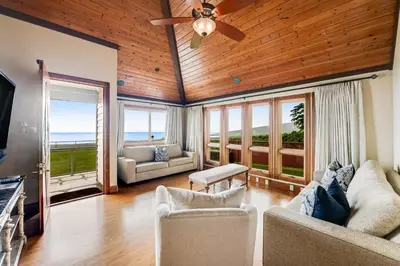 a living room with a ceiling fan and views of the ocean at ENC-183 - SeaBluffe Escape in Encinitas