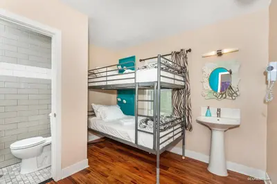 a bunk bed room with a toilet and a sink at Samesun Ocean Beach Hotel & Hostel in San Diego