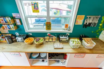 a room with a counter with food and a window at Samesun Ocean Beach Hotel & Hostel in San Diego