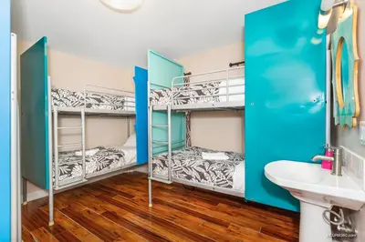 two bunk beds in a room with a sink at Samesun Ocean Beach Hotel & Hostel in San Diego