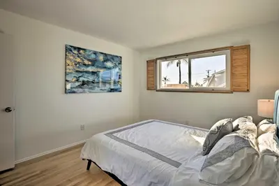 a bedroom with a bed and a window at Oceanside Home with Patio and Grill, Walk to Beach! in Oceanside