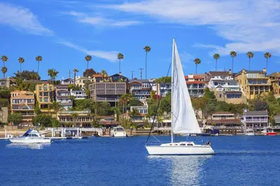 a sail boat in a body of water with buildings at 307 Thirty Fifth Street in Newport Beach