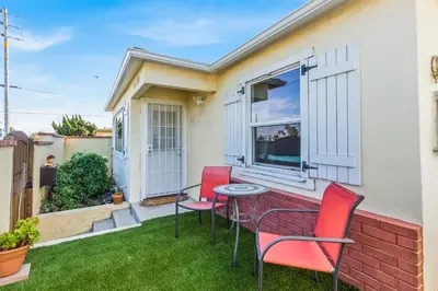 a patio with two chairs and a table in front of a house at Pacific Sunrise in San Diego